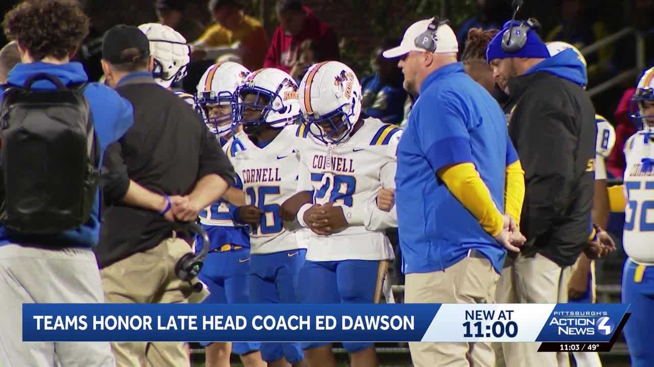 Cornell football players honoring Coach Ed Dawson on the field.